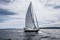 cruising sailboat with white sails billowing in the wind Royalty Free Stock Photo