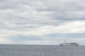 Cruising ship going with beautiful dramatic clouds Royalty Free Stock Photo
