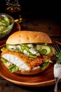 Crumbed fish burger with cucumber