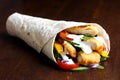 Crumbed fried chicken and salad tortilla wrap with white sauce i Royalty Free Stock Photo