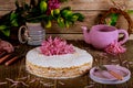 Crumble cake with fresh flowers, plate, teapot