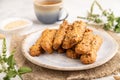 Crumble cookies with seasme and almonds on ceramic plate with cup of green tea on gray concrete background. side view, close up,