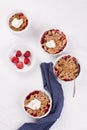 Crumble with oatmeal, wholemeal and strawberry in white bowls Royalty Free Stock Photo