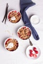 Crumble with oatmeal, wholemeal and strawberry in white bowls Royalty Free Stock Photo