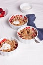 Crumble with oatmeal, wholemeal and strawberry in white bowls Royalty Free Stock Photo