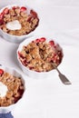 Crumble with oatmeal, wholemeal and strawberry in white bowls Royalty Free Stock Photo