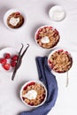 Crumble with oatmeal, wholemeal and strawberry in white bowls Royalty Free Stock Photo