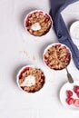 Crumble with oatmeal, wholemeal and strawberry in white bowls Royalty Free Stock Photo