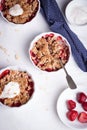 Crumble with oatmeal, wholemeal and strawberry in white bowls Royalty Free Stock Photo