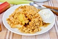 Crumble with rhubarb and ice cream in bowl