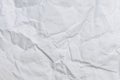 Crumbled paper top view close-up of crumpled sheet of white paper. Top view textured paper background, dark concrete Royalty Free Stock Photo