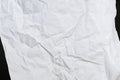 Crumbled paper top view close-up of crumpled sheet of white paper. Top view textured paper background, dark concrete Royalty Free Stock Photo