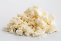 Crumbled white feta cheese on white.