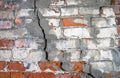 Crumbling brick wall with cracks Royalty Free Stock Photo