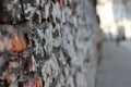 A crumbling old red brick wall background texture in shallow depth of field. stone wall selective focus Royalty Free Stock Photo