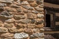 Crumbling stone wall of a building with open window in shadows, creative copy space