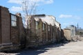 A crumbling wall of a destroyed plant with broken windows. Royalty Free Stock Photo