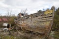 Crumbling wooden boat on the shore