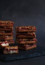 Crumbly biscuits with jam in rows on a dark background