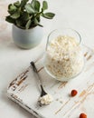 Crumbly fresh cottage cheese in a glass, with natural accents for a healthy meal Royalty Free Stock Photo