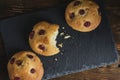 Crumbly homemade cookies with filling on slate.