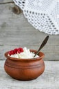 Crumbly homemade cottage cheese in a clay pot