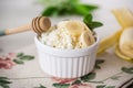 crumbly organic cottage cheese with honey and bananas in a ceramic bowl