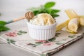 crumbly organic cottage cheese with honey and bananas in a ceramic bowl
