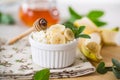 crumbly organic cottage cheese with honey and bananas in a ceramic bowl