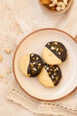 Crumbly vanilla-chocolate homemade cashew cookies and mango marmalade on a light beige background. natural sweets. cozy