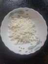 Crumbly white cottage cheese in a plate