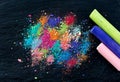 Crumbs of multi-colored chalk on a black background. Joy, Carnival, Panorama. A game for children. Art