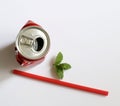 Crumpled aluminum can and red drinking straw. Royalty Free Stock Photo