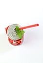 Crumpled aluminum can and red drinking straw. Royalty Free Stock Photo