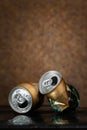 Crumpled beer cans. Two wet crumpled open beer cans with drops on a brown background. AMSTEL is a world famous brand from the