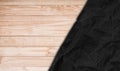 Crumpled black paper on oak wood texture background Royalty Free Stock Photo