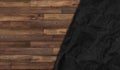 Crumpled black paper on wood texture background Royalty Free Stock Photo