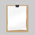 Crumpled blank white paper sheet with black binder clip on kraft board Royalty Free Stock Photo