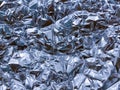 Crumpled blue foil texture. Shiny festive background. Metallized paper. Royalty Free Stock Photo