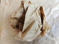 Crumpled brown wax paper wrapper in a ball Royalty Free Stock Photo