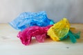 Crumpled colorful plastic bags and wraps on wooden table Royalty Free Stock Photo