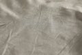 Crumpled dark beige fabric as background, closeup view