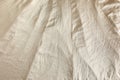 Crumpled dark beige fabric as background, top view