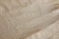 Crumpled dark beige fabric as background, top view