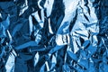 Crumpled dark blue foil shining texture background, bright shiny cold icy design, metallic glitter surface Royalty Free Stock Photo