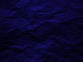 Crumpled dark blue paper texture background