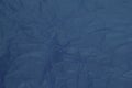 Crumpled dark blue tissue paper for background or gift wrapping.