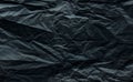 Crumpled dark gray wrapping paper slightly blurred