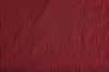 Crumpled dark red fabric as background, top view