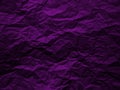 Crumpled dark violet paper texture background